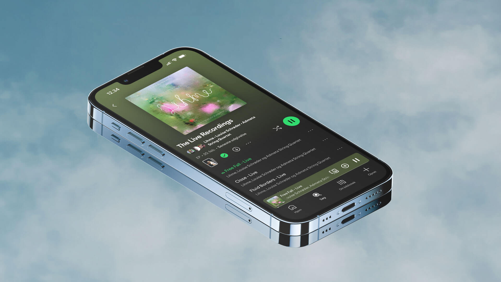 Spotify album in an iphone on a mirror reflecting the sky by Camilla Wedege
