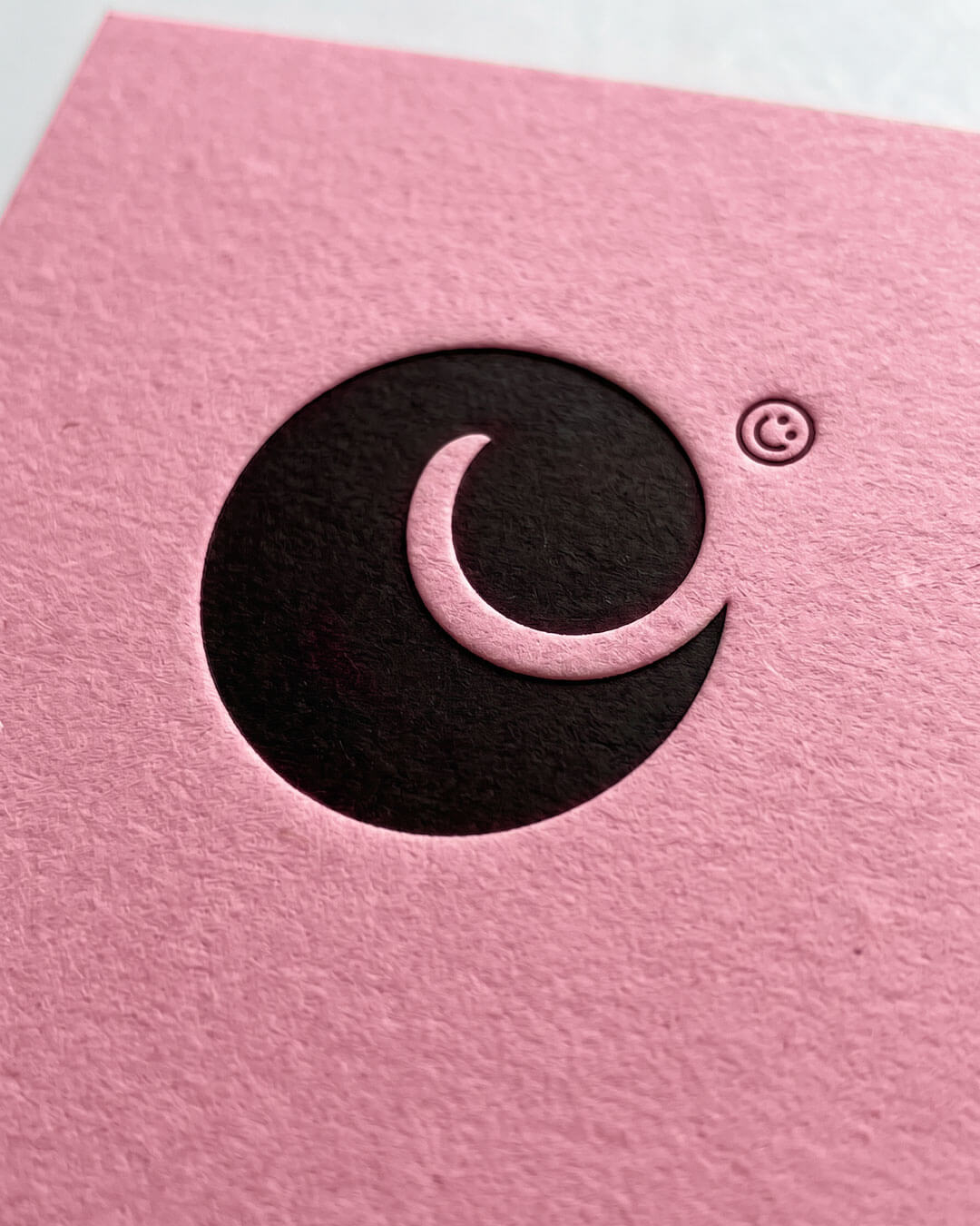 Camilla Wedege Studio logo icon debossed onto pink paper by Camilla Wedege